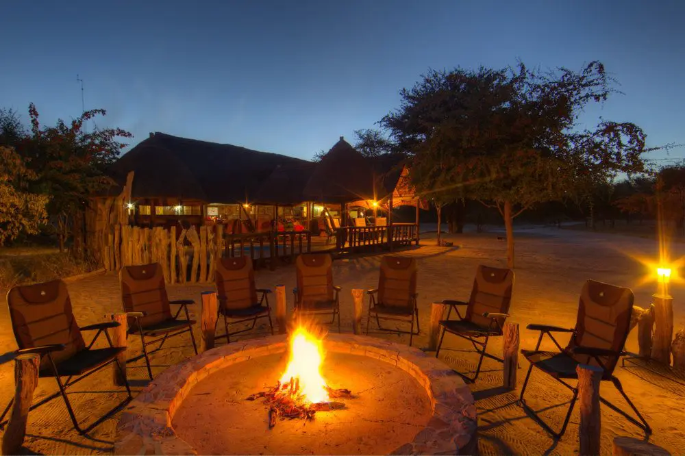 Guests around the campfire at a Zambian safari camp
