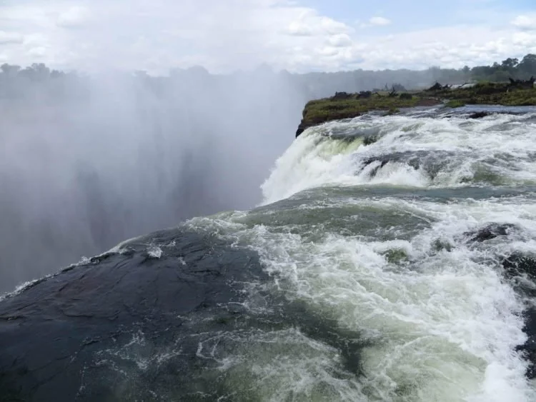 Swimmers at Devil's Pool on the edge of Victoria Falls